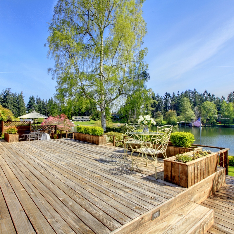 Large wood deck with lake and spring landscape